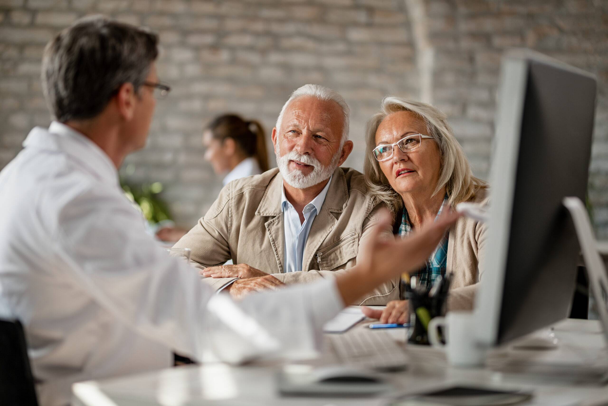 Senior couple consulting with a dentist during a treatment discussion